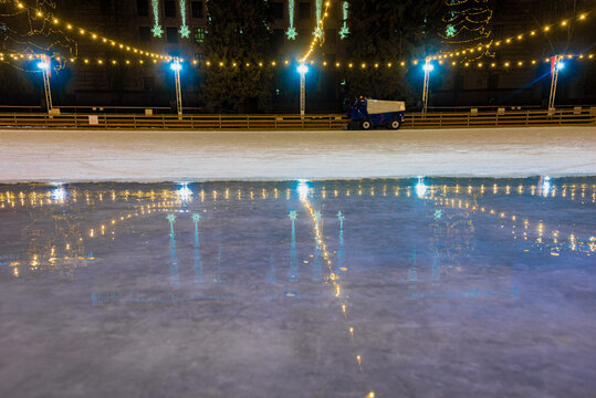 Background Of Festive Ice Skating Rink With Resurfacing Machine