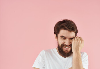 Emotional man on a pink background gesturing with his hands close-up cropped view