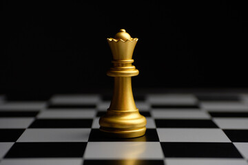 Gilded chess piece queen on the board