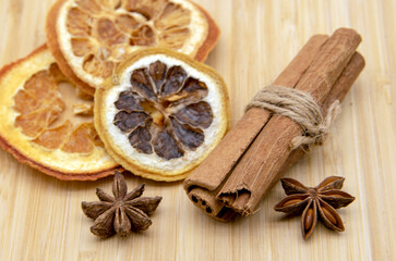 Fototapeta na wymiar Cinnamon sticks, star anise, and dried oranges lie on a tray.