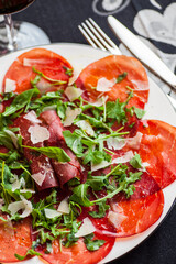 Closeup photo of dish with italian bresaola and ruccola. Selective focus - shallow depth of field.