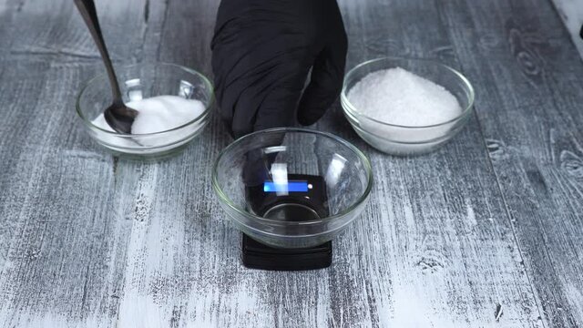 The cook weighs on an electronic scale table salt and nitrite