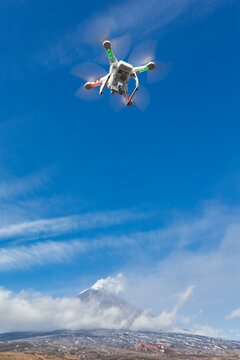 Flying Drone Quadcopter UAV Aerial Videography In Sky On Background Of Volcano Eruption, Mountain Peak Erupting Ashes, Plume Volcanic Gas From Active Crater. Kamchatka Peninsula, Russia - Oct 1, 2016