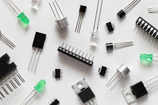 Microcontrollers, transistors, green LEDs, microcircuits, thyristors on a white background. Radio Components