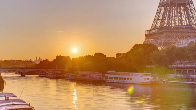 Eiffel Tower and the Seine river at Sunrise timelapse, Paris, France. Morning view from Bir-Hakeim bridge with reflections on water