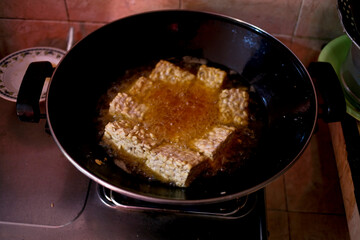 frying pan with tempe. Traditional food from soybean fermentation