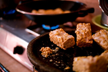 frying pan with tempe. Traditional food from soybean fermentation
