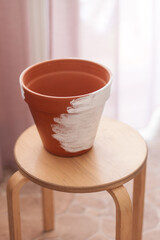 ceramic flower pot on wooden chair, white paint dyeing process, handmade, hobby, close-up, no people, flower transplant, anti-stress
