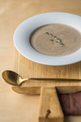 Mushroom cream soup in a white  plate. Cream of champignon soup 
