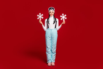 Full size photo of young happy cheerful smiling girl hold paper snowflakes wear blue trousers...