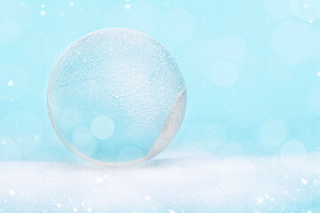Snowglobe or glass ball covered by snow with glitter, Christmas decoration, layout, space for text,...