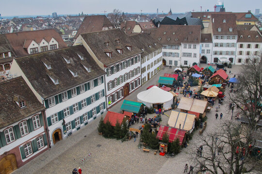 Aerial view of main square,Munsterplatz with famous Christmas markets in Basel,Switzerland. Beautiful European cityscape.X-mas decoration.People from above strolling on the market.Swiss architecture.