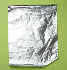 gray foil for baking and packaging food on a green background