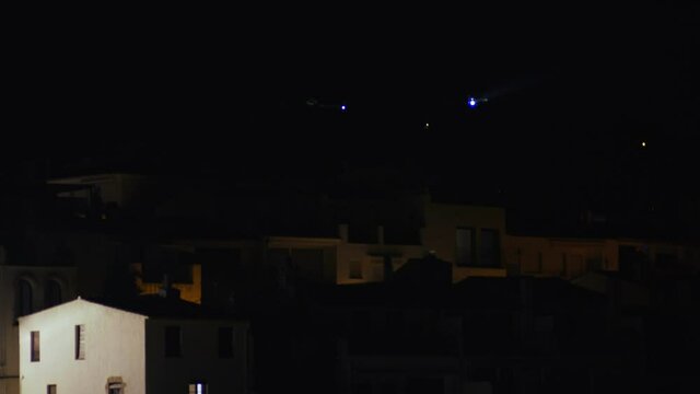 Beautiful Mediterranean village at evening. Night views on a small town on a sea coast. Water and lights of Calella de Palafrugell in Spain. Costa Brava vacation an chill. White houses on the beach..