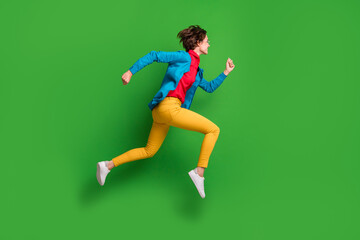 Fototapeta na wymiar Full length body size side profile photo of jumping running girl in colorful clothes isolated on vibrant green color background