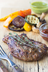 grilled steak grilled on a wooden background, with spices. grill strips visible on steak