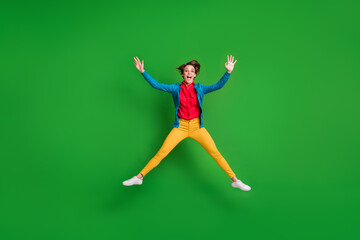 Plakat Full length body size photo of careless childish female student jumping like star isolated on bright green color background