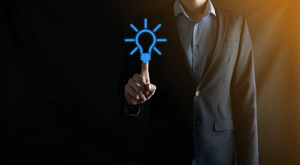 Businessman in a suit with a light bulb in his hands. Holds a glowing idea icon in his hand. With a place for text