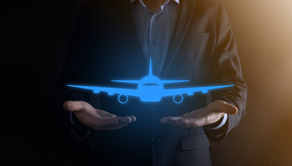 Businessman holding an airplane icon in his hands. Online ticket purchase.Travel