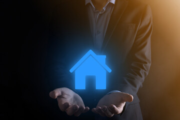 Fototapeta na wymiar Real estate concept, businessman holding a house icon.House on Hand.Property insurance and security concept. Protecting gesture of man and symbol of house.