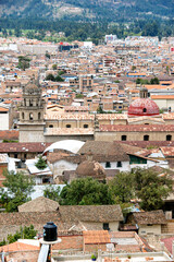 Fototapeta na wymiar Cityscape view of Cajamarca, Peru from Apolonia hill church dome and tower. Roof tiles and colonial buildings.