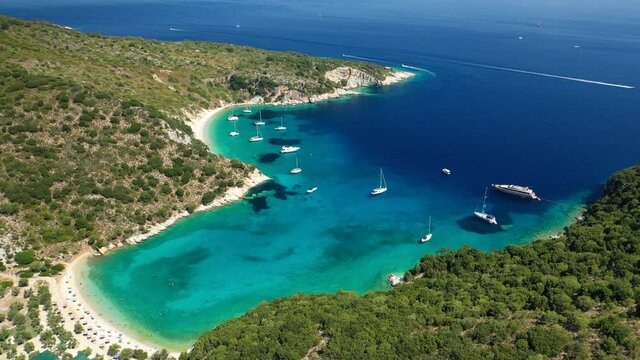Aerial drone video of turquoise paradise sandy beach and bay of Filatro a safe sail boat anchorage in Ithaki or Ithaca island, Ionian, Greece