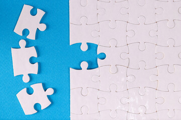 Folded white jigsaw puzzles blue background business Challenges and solutions concept
