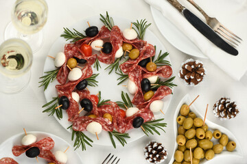   Christmas wreath - antipasto. Salami canapes with olives, baby mozzarella.