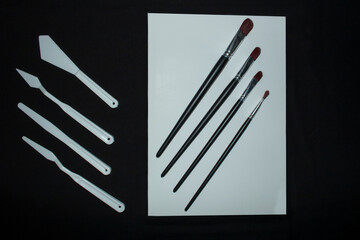 variety of palettes and brushes for oil painting