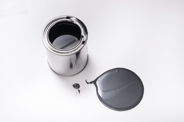 Metal tin can with black paint on white background