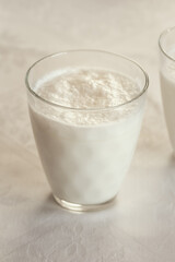 A glass of goats milk kefir on a table