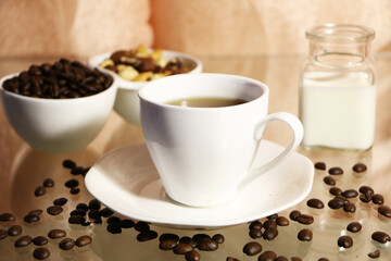  The concept of home comfort and warmth. On the table, a cup of coffee and a cake against a background of pink curtains.