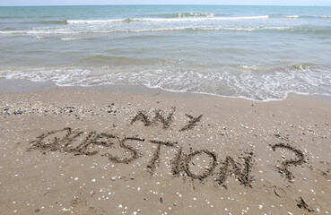 text any question written in the sand of the beach by the sea