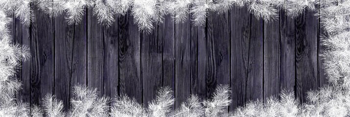 Old wooden background with white twigs border. Winter frame with place for your text. 