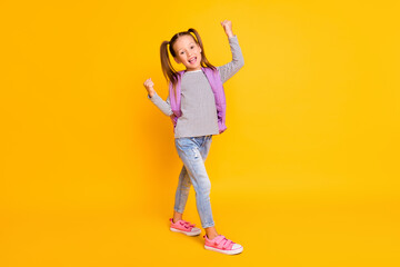 Fototapeta na wymiar Full size photo of happy excited schoolgirl child kid wear purple backpack isolated on yellow color background