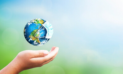 Earth is wearing protection mask on nature blurred background ,Elements of this Image Furnished by NASA. 