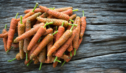 Long pepper on wood background
