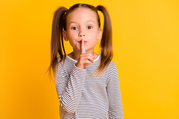 Portrait of young beautiful cute girl kid child hold finger on lips showing silence isolated on yellow color background - obrazy, fototapety, plakaty