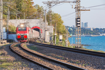 Naklejka premium Passenger train moves from the tunnel. Sochi. Russia.