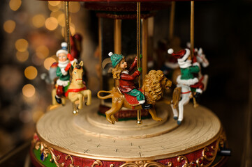 close-up on christmas toy carousel with figures of cheerful children inside it © fesenko