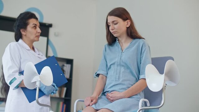 Teenager Pregnant Feeling Sad Empathy While Visit Gynecologist Doctor at the Medical Clinic. Young Girl, Not Ready for Pregnancy. Female Gynecologist Supporting Upset Teenager Pregnant