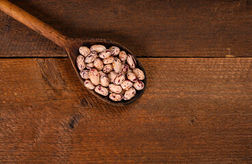 Obraz na płótnie Canvas Colored beans on wooden background.