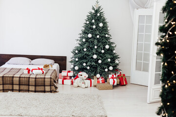 Christmas tree with gift decor bedroom with bed new year feast winter background