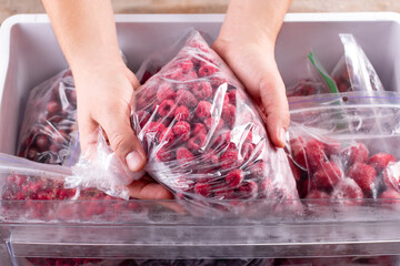 Frozen raspberries. Frozen berries and fruits in a plastic bag in refrigerator