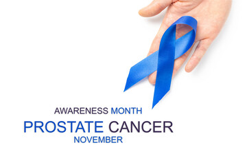 Blue ribbon. Awareness prostate cancer of men health in November. Blue ribbon in hands isolated on white background. Symbol of oncology affected man. Copy space.