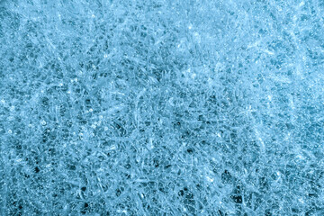 Fototapeta na wymiar Blue cracked ice background. Frozen water, sea