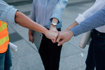 Engineers coworkers join hands to build successful projects. Teamwork concept.