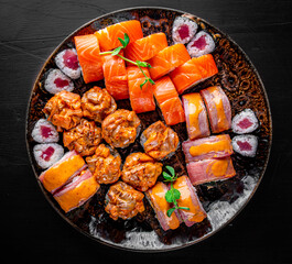 set of sushi roll with salmon, avocado, cream cheese, cucumber, rice, tuna in plate on black background