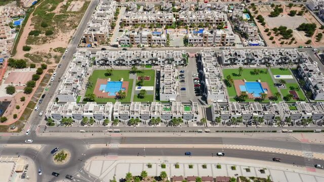 Housing estates in La Zenia, Alicante, Spain. Aerial showing rows of houses, big neighborhoods during summer sunny day.