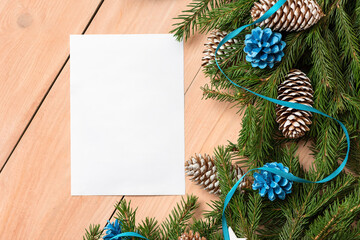 Fototapeta na wymiar A piece of paper for text next to Christmas tree decorations.